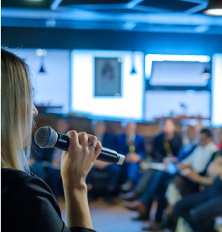 Candid photo of a presenter sharing results with an engaged audience